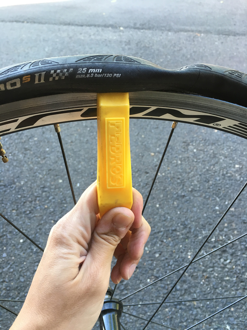 Insert your tire lever and start working the tire off of the wheel. You may need to use two levers if you are having trouble getting the tire off.
