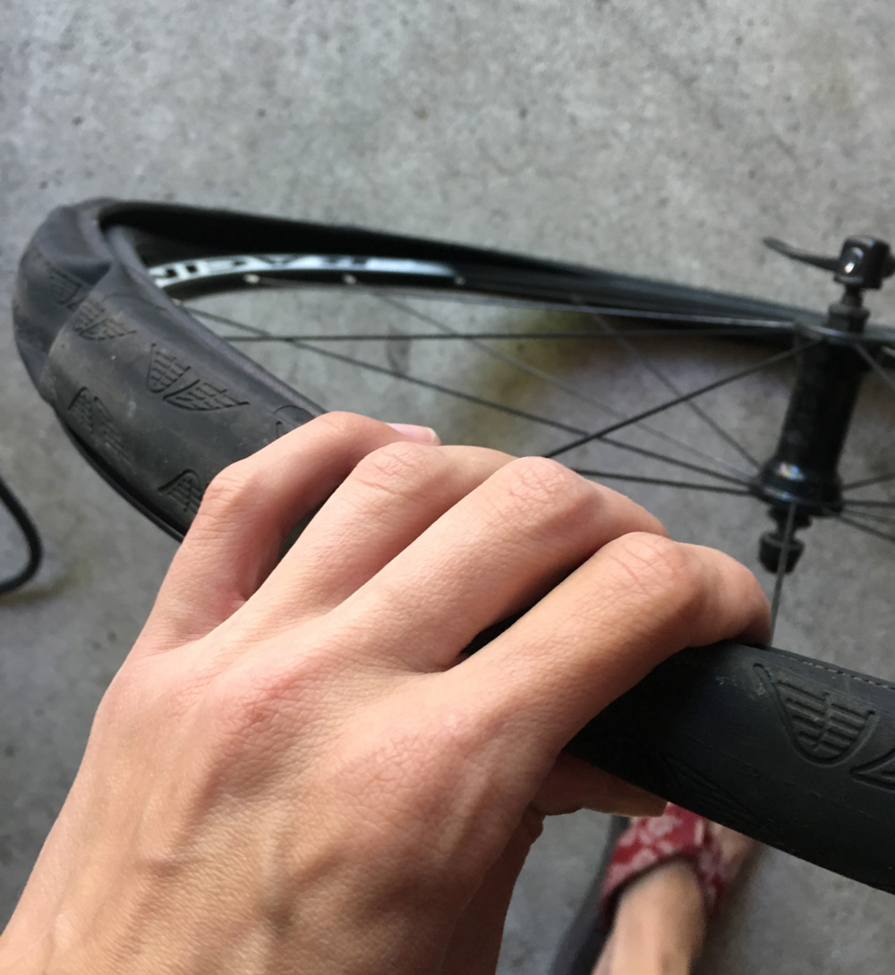 Use your hands to start working the tire back onto the rim. Sometimes the last bit is hard to get on, but just keep working it and it will pop back in place.